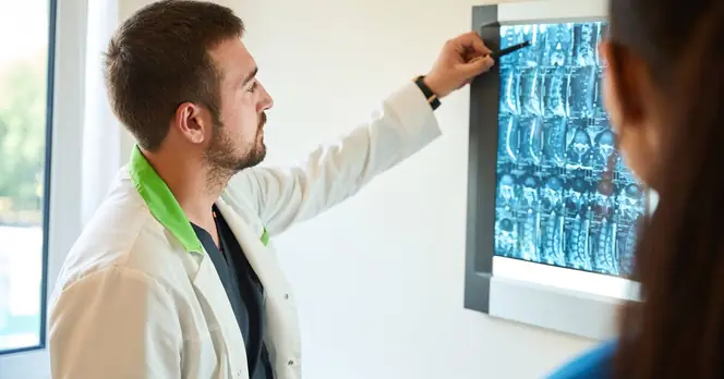Healthcare Professionals Discuss Spine Health in Medical Office